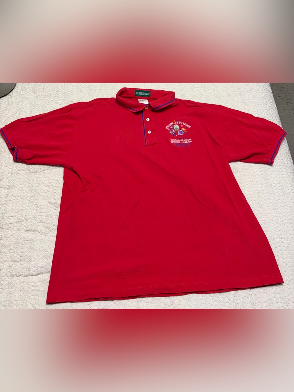 Outer Banks Red Polo with Embroidered 'Celebrate Freedom' Crest
